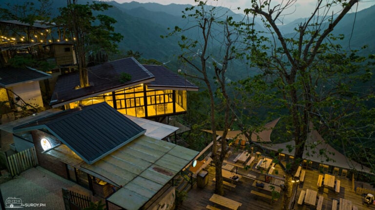 An aerial view of The Glasshouse at Charlie’s Cup in Busay, showcasing its stunning location nestled in the hills with breathtaking panoramic views.