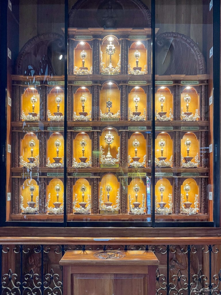 A sacred display of holy relics inside the Basilica Minore del Sto. Niño, showcasing treasured artifacts of various saints revered by the faithful.