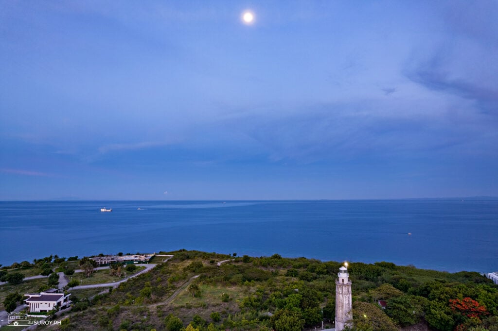 Admiring the lighthouse in Liloan with the view of the sea during the full moon. 