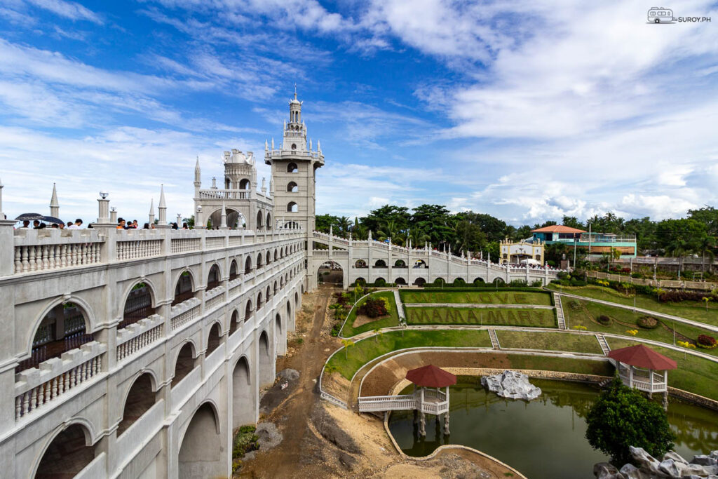 An expansive view of Simala's stunning architecture and lush gardens showcasing the phrase ‘I Love Mama Mary’ beautifully landscaped on the grounds.
