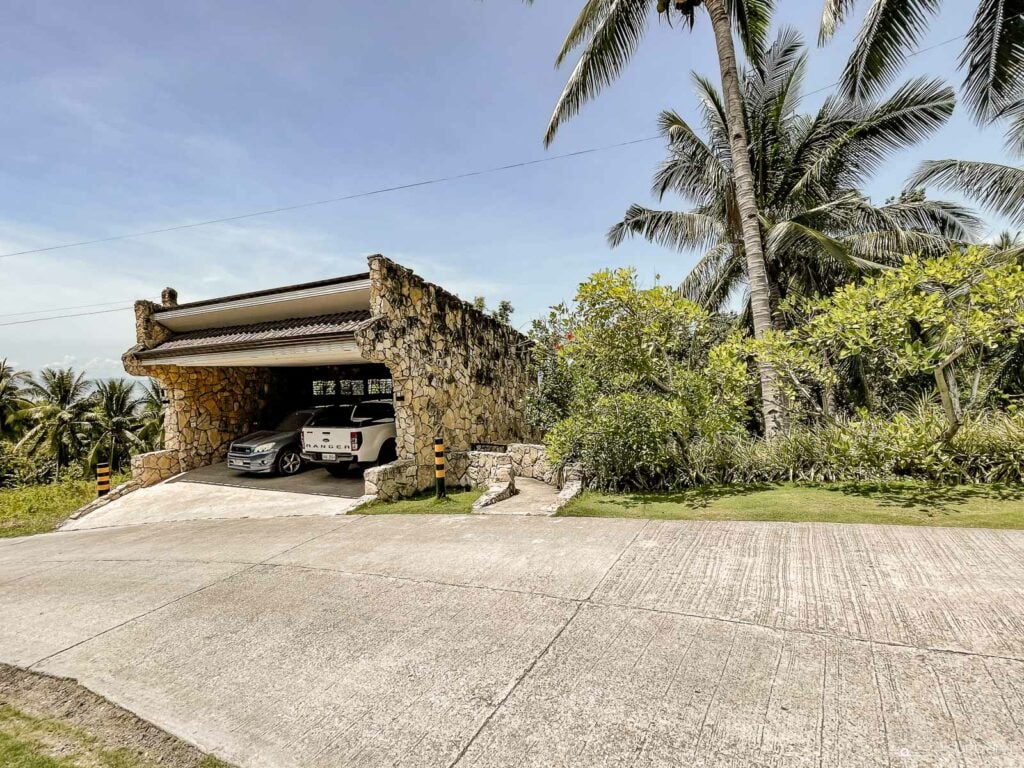 The gate beside the modern-looking garage is the gateway to the waterfalls. 