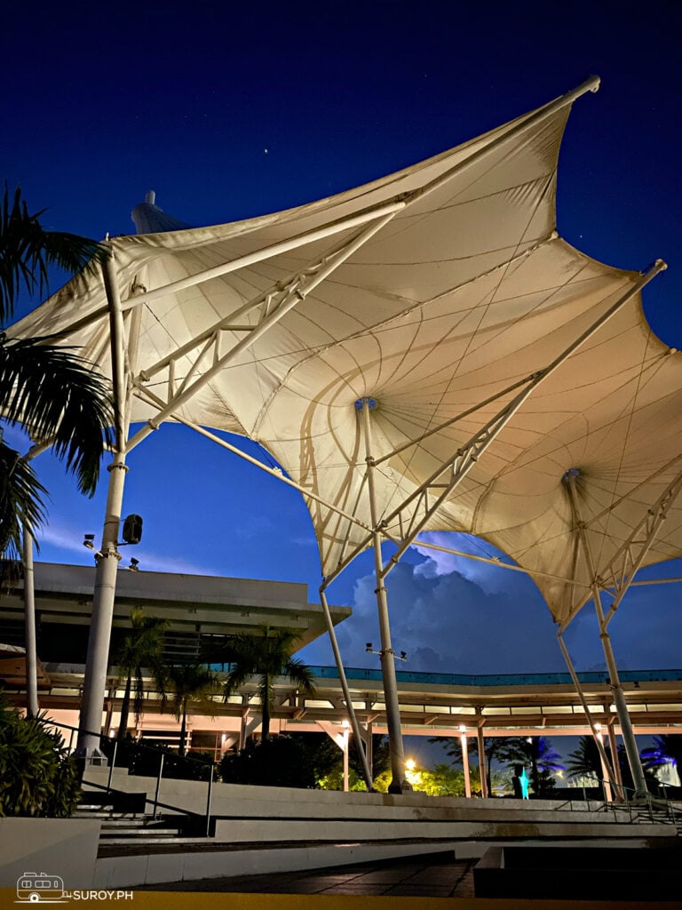 The illuminated tent structures create a captivating atmosphere for evening strolls and gatherings.