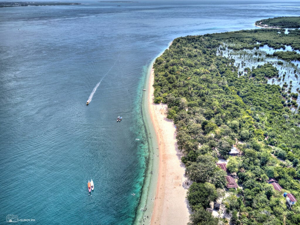 Small boats (bangka) passing by Grande Sta. Cruz Island.