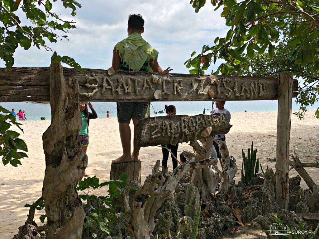 A person poses by the signboard "Santa Cruz Island Zamboanga City".