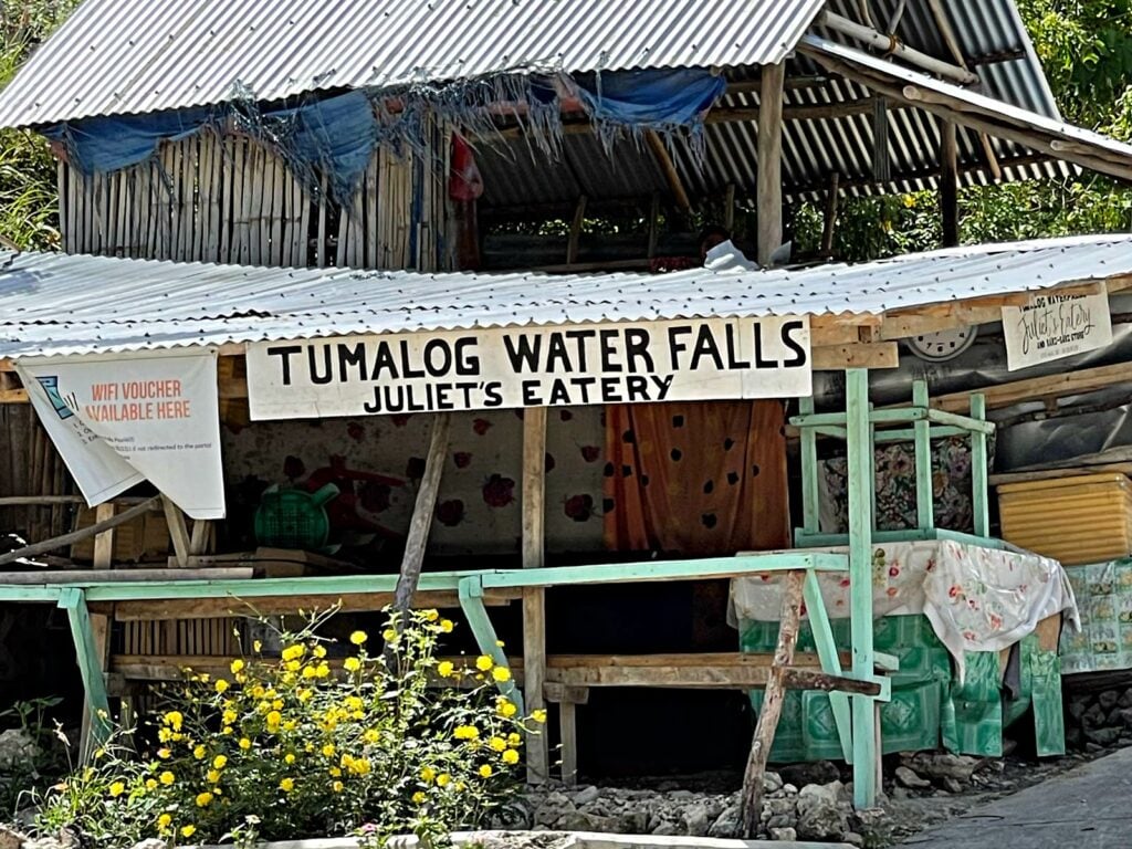 The sign leading to the entrance of the waterfalls is also an eatery. 