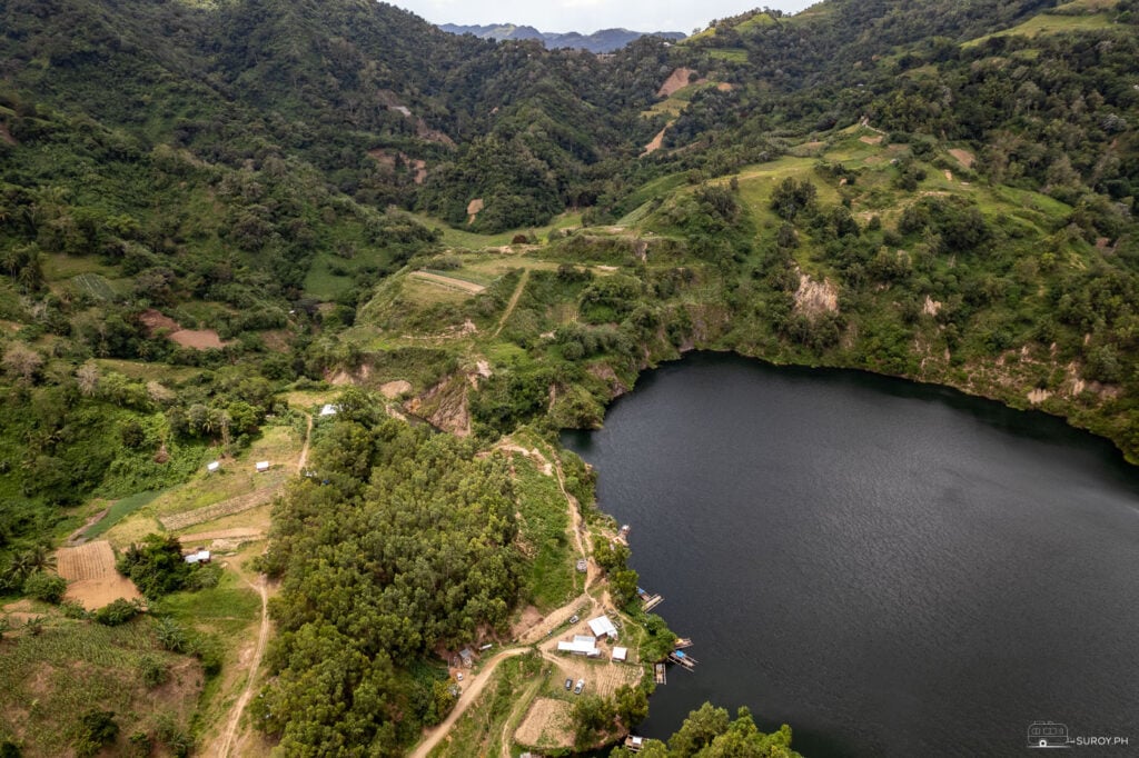 A stunning aerial view of Lake Bensis, a hidden gem surrounded by lush greenery and rolling hills.