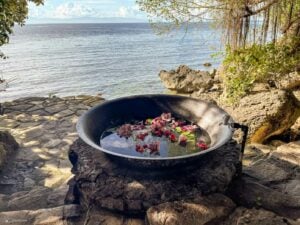 Kawa Herbal Bath: A beautifully prepared Kawa bath with floating flowers and herbs, providing a unique and picturesque way to relax and enjoy the natural surroundings at Fantasy Lodge.