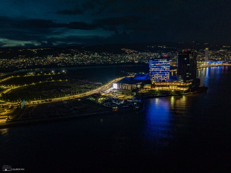 NUSTAR Resort Cebu illuminated at night beside the SRP waterfront