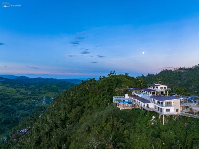 Aerial View of Serenity Farm and Resort: An aerial view showcasing the luxurious Serenity Farm and Resort nestled in the lush hills of Busay.