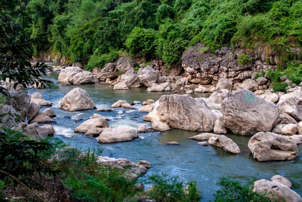 There are beautiful rock formations by the river. 