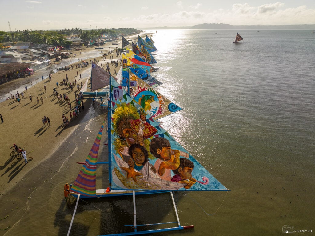 Colorful Paraws line up at the Villa Beach during sunrise ready to set sail. 