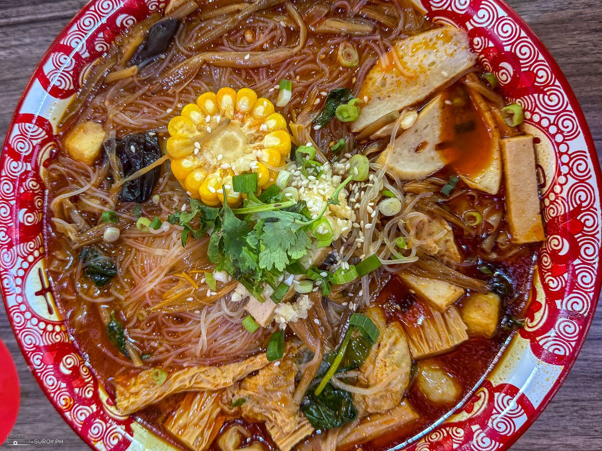 A hearty bowl of malatang featuring fresh corn, mushrooms, and a variety of savory ingredients at Yang Hero in Cebu City.