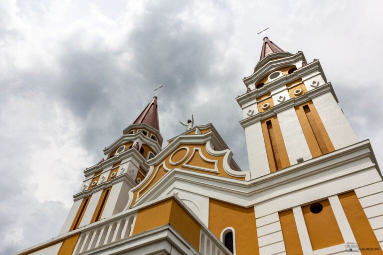 The majestic towers of The Transfiguration of Our Lord Cathedral stand tall, a beacon of faith and hope against the dramatic sky.