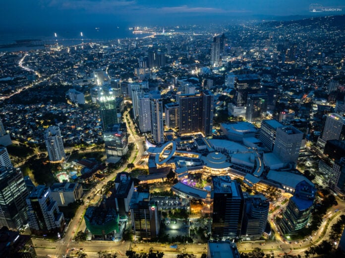 The serene beauty of Cebu Business Park at twilight, with CCLEX in the background, and with Ayala Center Cebu standing as a beacon of activity and excitement.