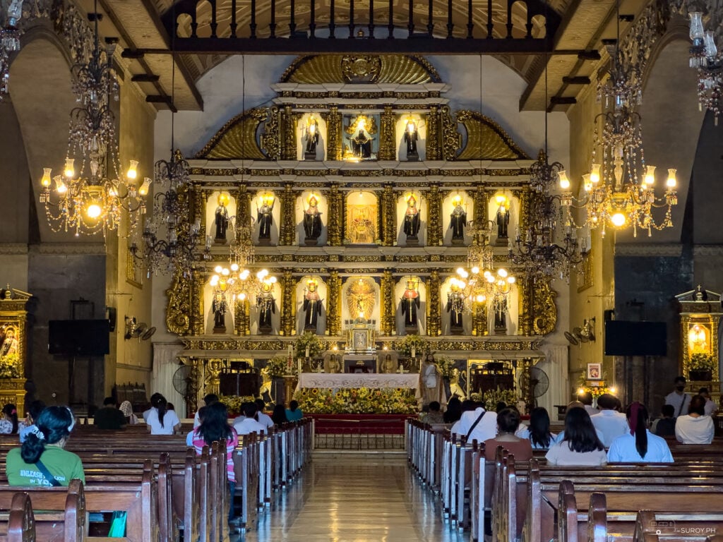 The majestic altar of the Basilica Minore del Sto. Niño, adorned with images of saints, invites the faithful to experience its historical and spiritual grandeur.