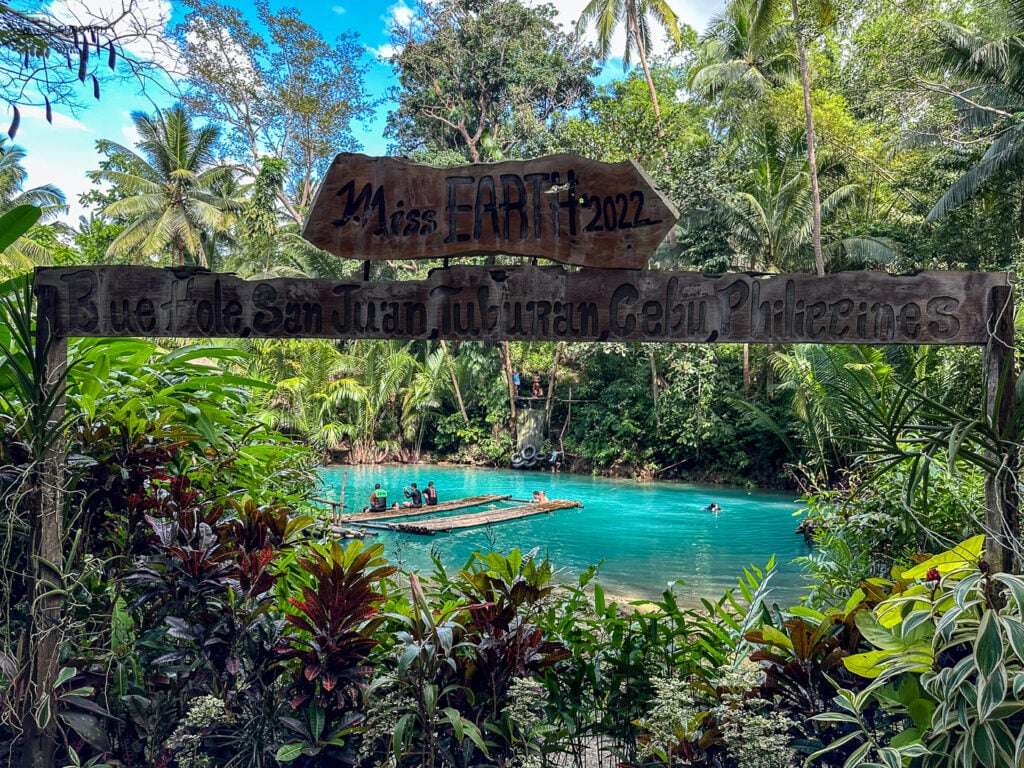 Welcome to Paradise - The entrance to Tuburan Blue Hole Spring invites you into a serene oasis of natural beauty. 