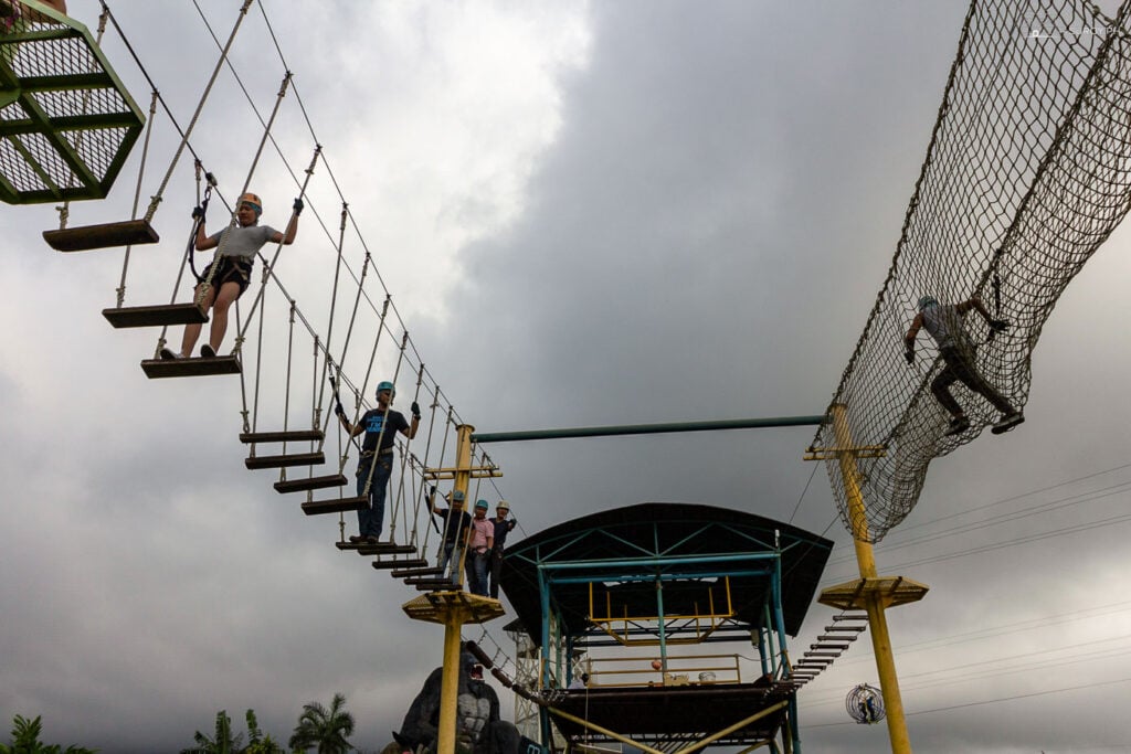 Test your agility and courage with friends on the exhilarating rope course, a highlight of the Campuestohan Highland Resort experience.