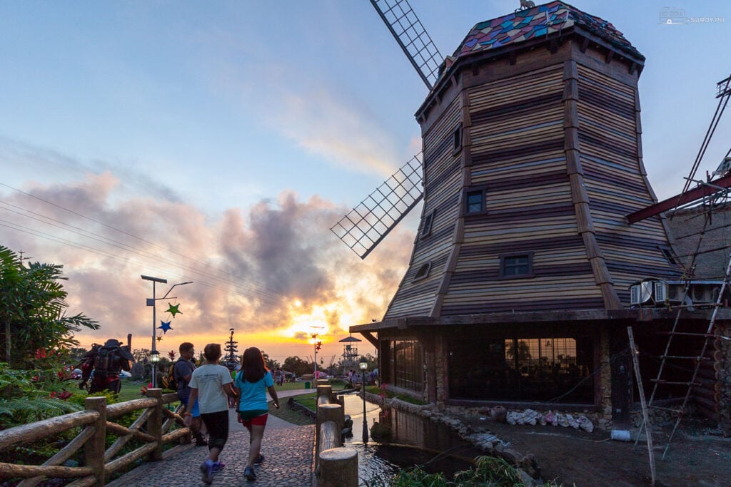 Witness the enchanting silhouette of the windmill against a stunning sunset, capturing the timeless charm of the resort.