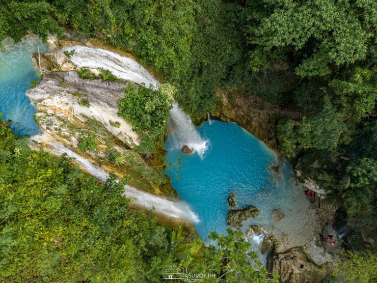 Drone shot of Inambakan Falls in Ginatilan, Cebu, featuring a turquoise pool and two separate streams of cascading water formed after Typhoon Kristine.