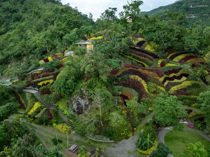 An aerial view of Lakeview Le Jardin in Busay, showcasing the vibrant flower beds and the resort’s beautiful layout.