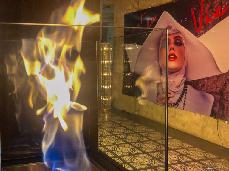 The mesmerizing fire display at the entrance of La Vie Parisienne in Busay adds a dramatic and cozy touch to the chic decor.