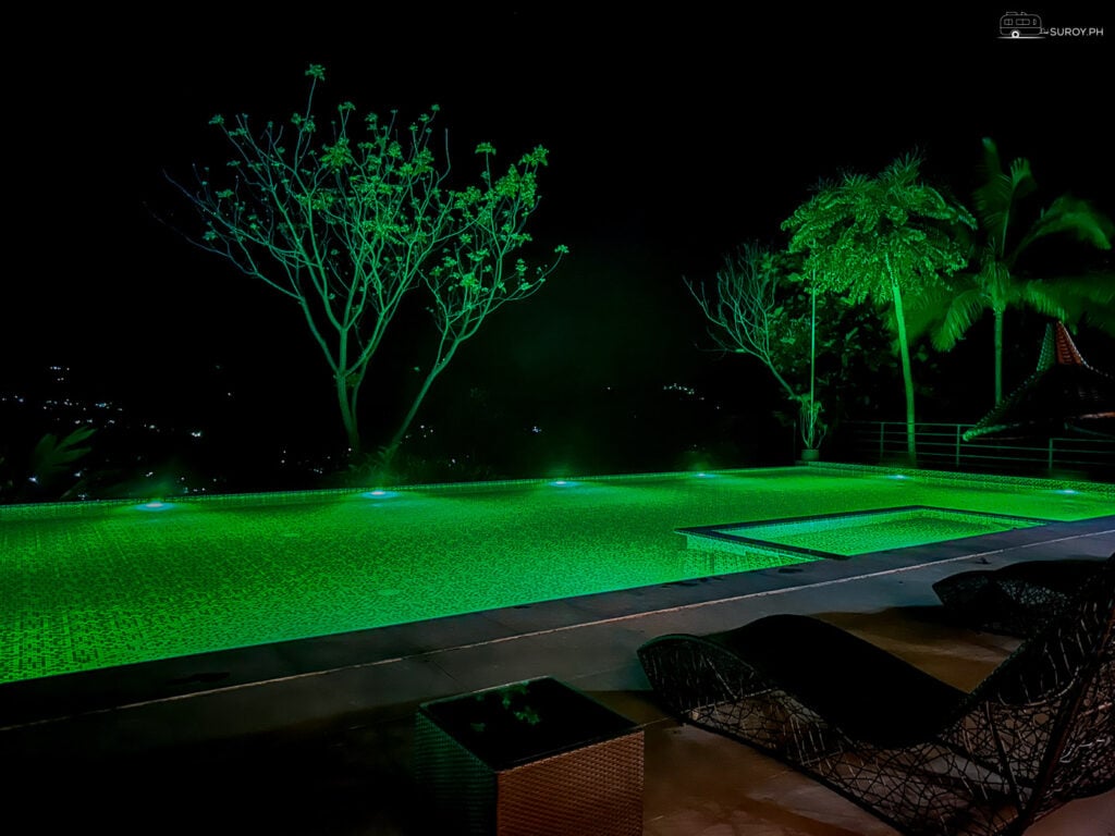 Experience the magical ambiance of the illuminated infinity pool at night.