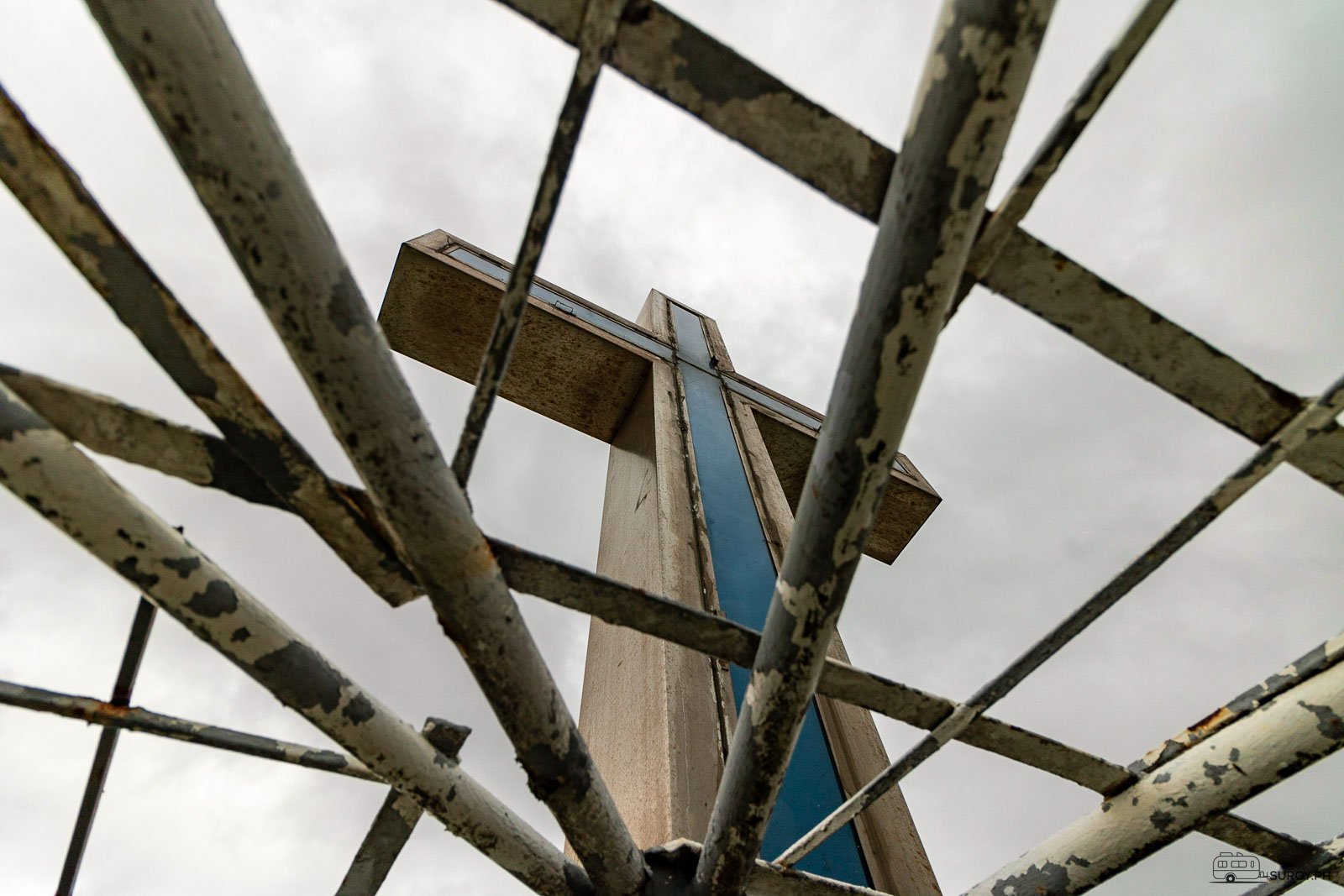 The cross above the seven-story tower.