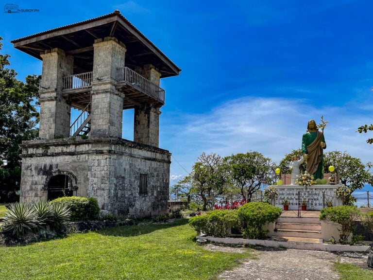 Stand in awe at the historic bell tower and the serene statue of Saint Joseph at Saint Michael the Archangel Parish, where history and devotion meet amidst the lush greenery of Samboan.