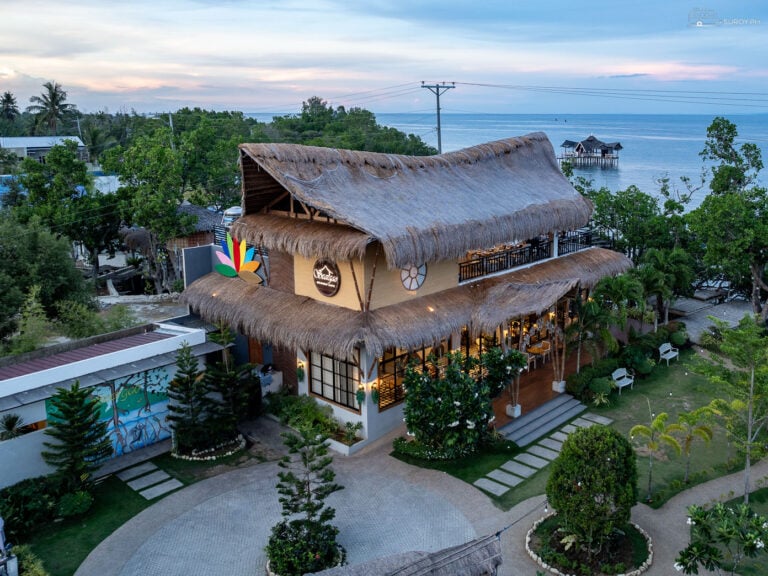 Experience the rustic charm of Seargao Seaview Cafe in Argao from above, showcasing its inviting open-air structure and beautiful surroundings.