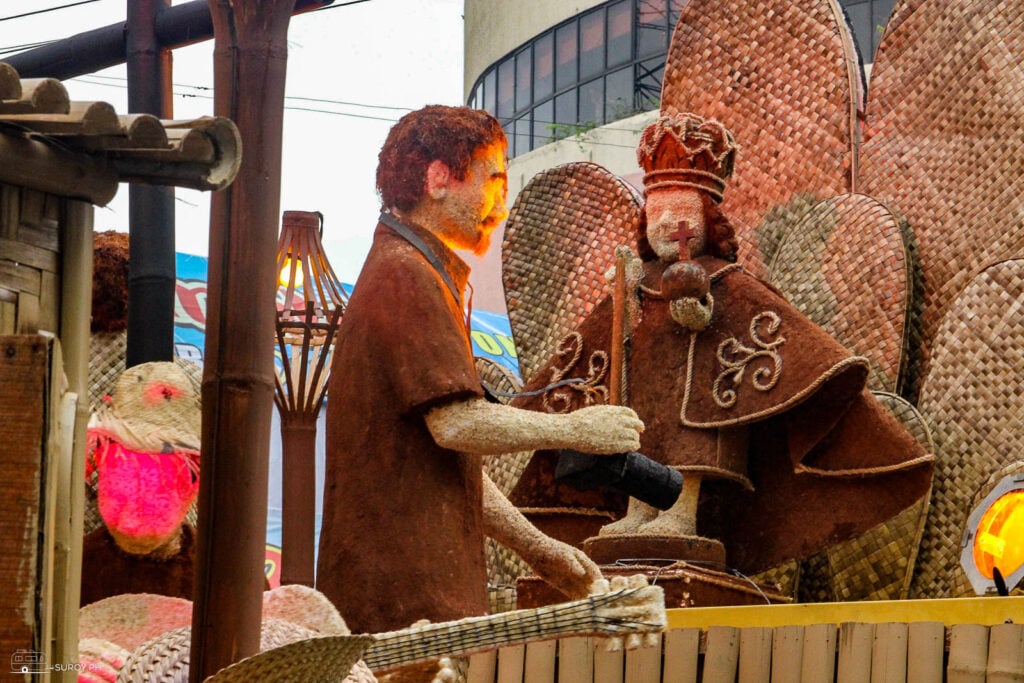 Intricate figures, symbolizing the deep-rooted devotion to the Santo Niño, come alive with vibrant colors and detailed artistry, capturing the essence of Cebu’s grand celebration.