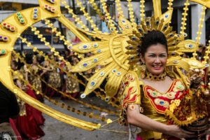 Performers hold the statue of Sto. Niño while dancing in praise