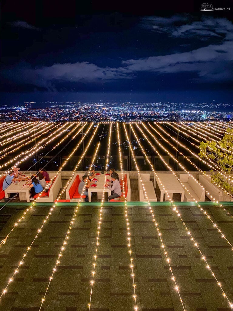 Experience the magic of twilight dining with the city lights spread out before you.