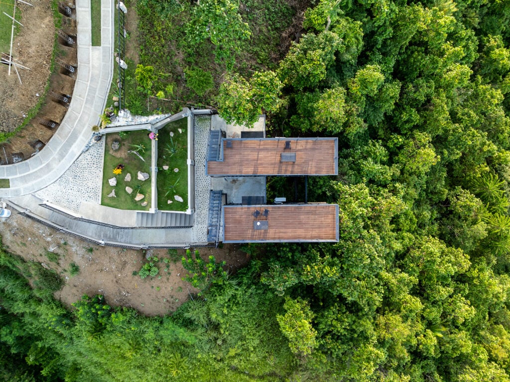 Aerial View of Tuburan 360 - Discover the perfect blend of architecture and nature from above. The balcony on top of the accommodation in Tuburan 360 offers a serene escape surrounded by lush greenery and breathtaking views.