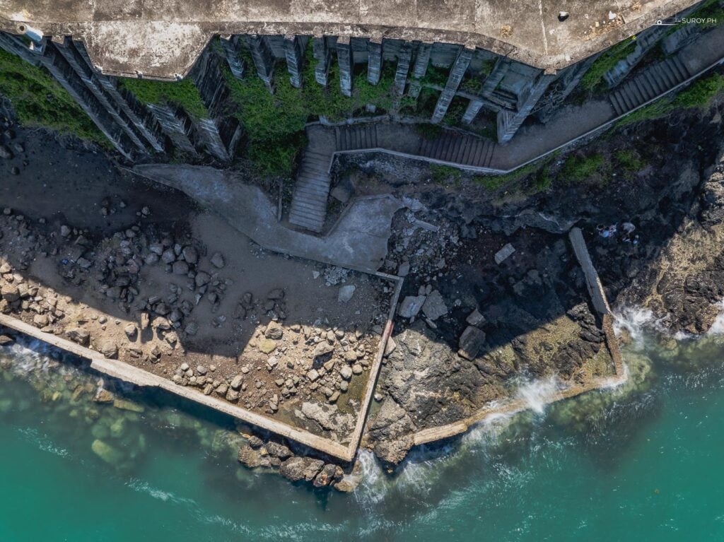 An overhead perspective of the Ruins of Alcatraz, revealing its full layout and proximity to the ocean.