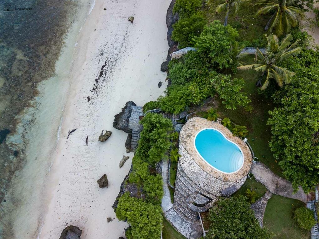 An oblong-shaped pool overlooking the pristine beach. 