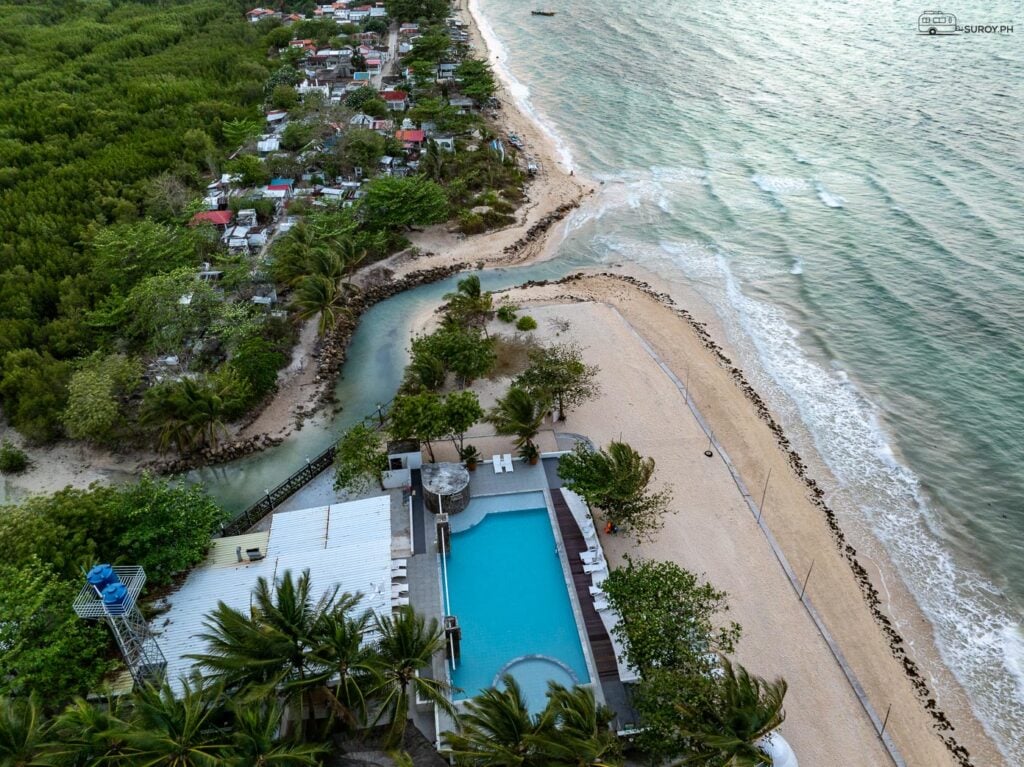 An aerial view of the swimming pool and lush greenery makes the resort a tropical paradise.