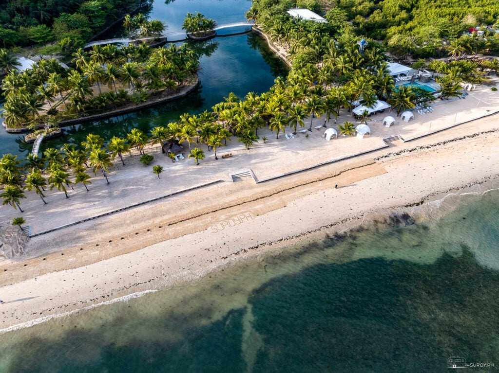 A breathtaking aerial view of the resort’s pristine beach and inviting waters highlight the perfect beach getaway.