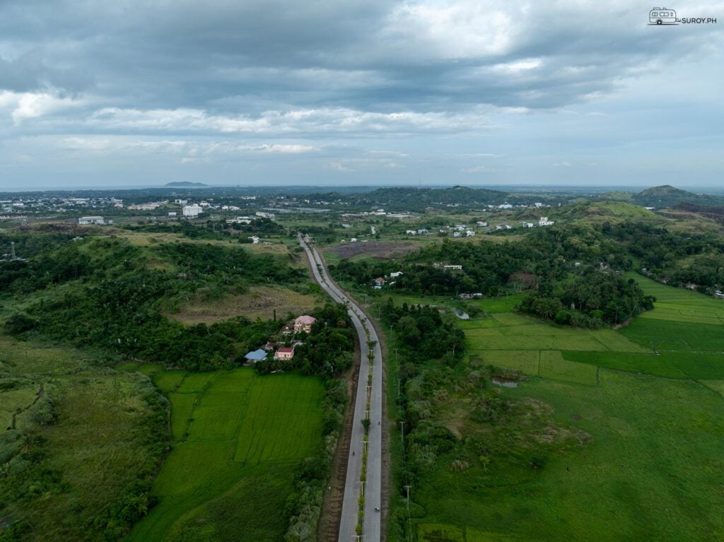 The Sacred Heart of Jesus statue watches over the scenic roads and lush greenery of Roxas City, inviting all to experience its serene beauty.