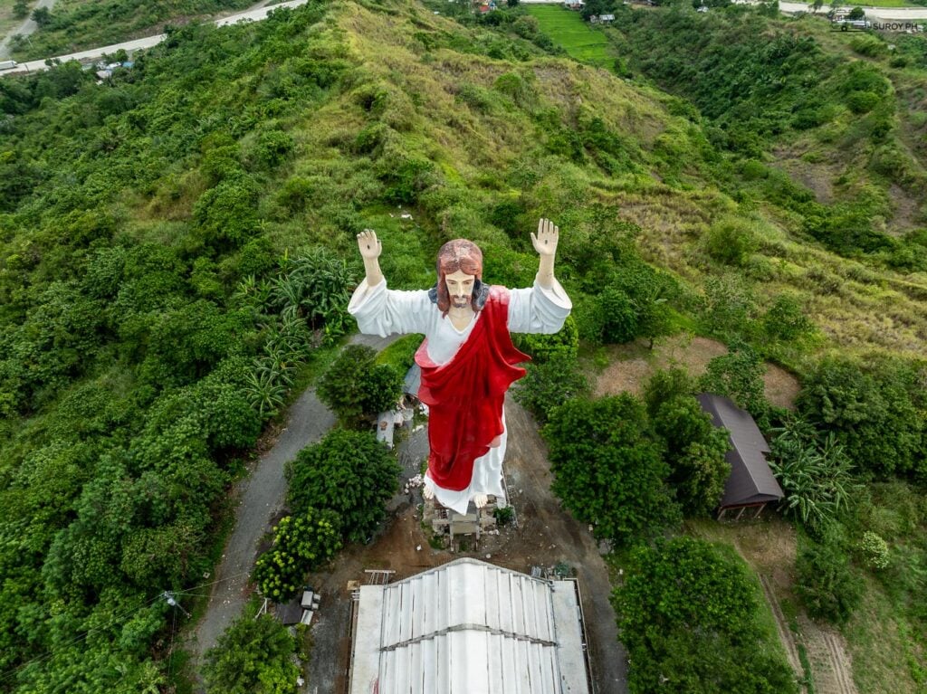 The towering figure of the Sacred Heart of Jesus overlooks the verdant hills and valleys, offering a tranquil escape for pilgrims and visitors alike.