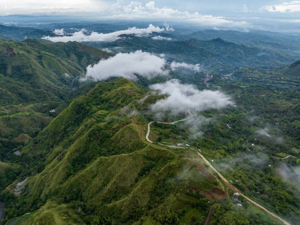 Mist-covered mountains creating a mystical ambiance as you approach the serene waterfalls of Guiritsan and Maigos.