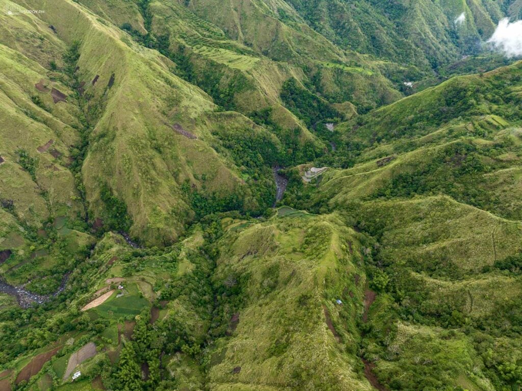 An expansive view of the rolling hills and verdant valleys in Tubungan, perfect for hiking and trekking adventures.