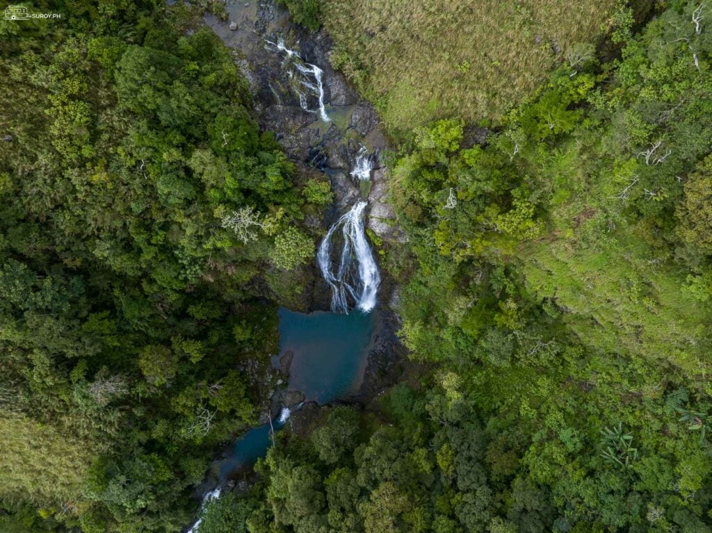 The cascading waters of Maigos Falls in Igbaras, as seen from above, create a series of serene pools perfect for a refreshing swim.