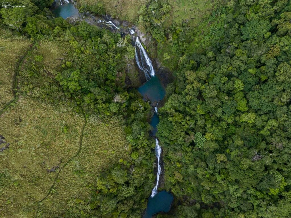 A breathtaking view of Guiritsan Falls, with its multiple tiers and crystal-clear pools nestled in the heart of the forest.