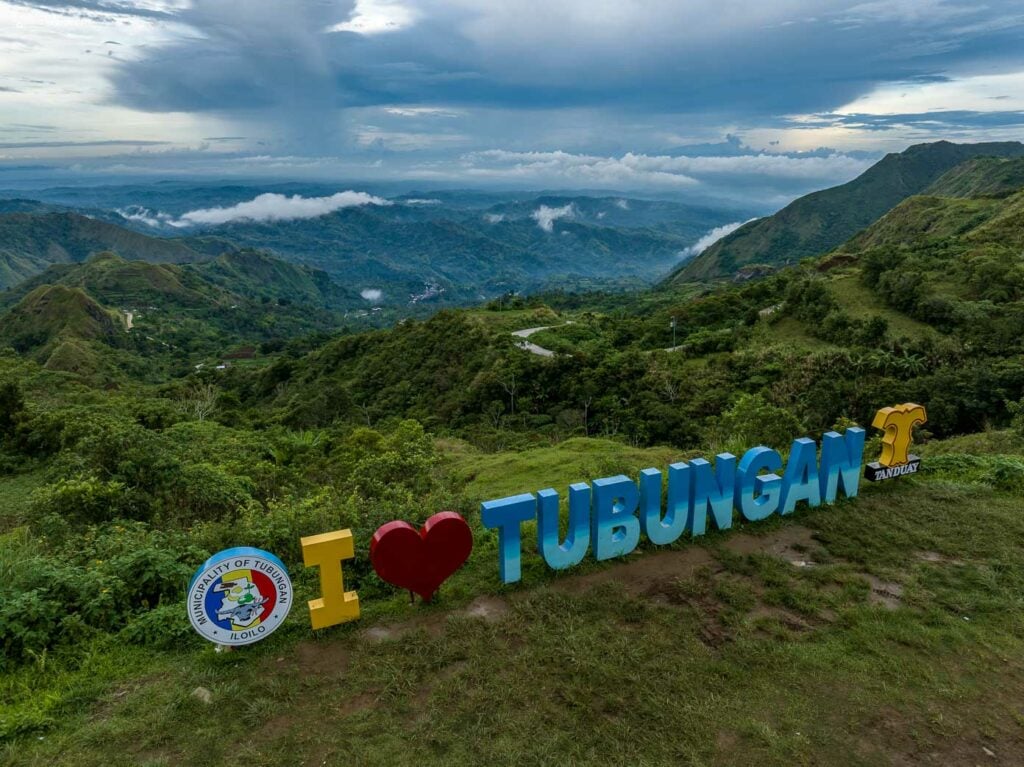 The ‘I Love Tubungan’ sign against a backdrop of lush mountains and expansive valleys, capturing the scenic beauty of the area.