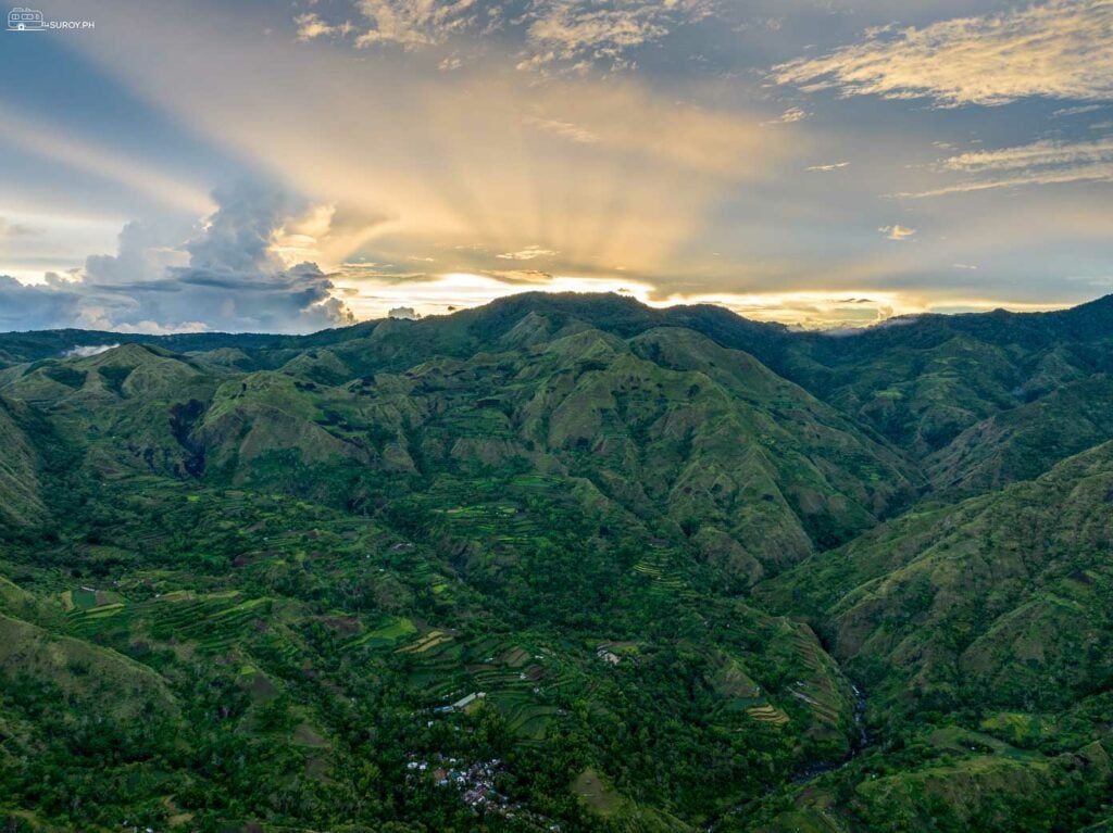 A mesmerizing sunset over the mountains of Tubungan and Igbaras, casting a golden glow across the valleys and hills.