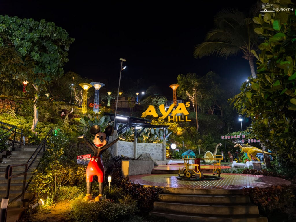 The entrance to Aya’s Hill, welcoming visitors with playful sculptures and lush gardens, sets the tone for a magical experience.