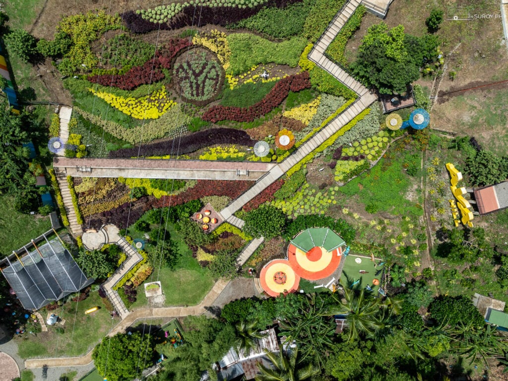 A bird’s-eye view of the beautifully landscaped gardens at Aya’s Hill offers a colorful, vibrant display that captures the essence of nature.