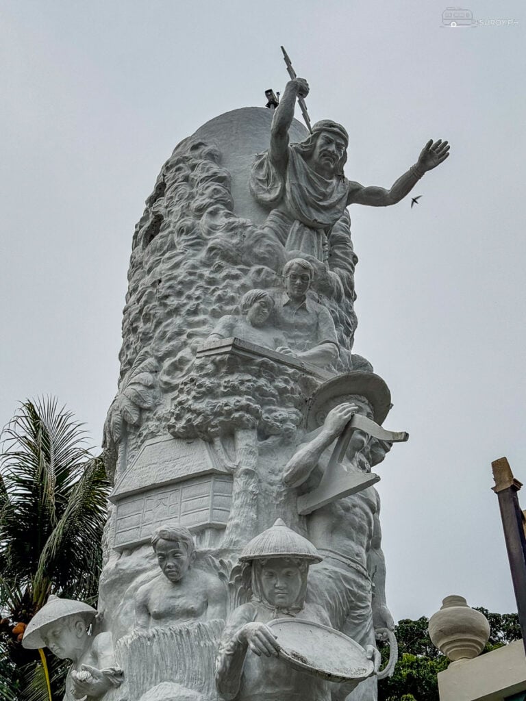 Detailed Sculpture Work at VSU Gate: Close-up of the stunning detailed artwork on the gate sculpture, featuring depictions of traditional farming, industry, and academic growth.