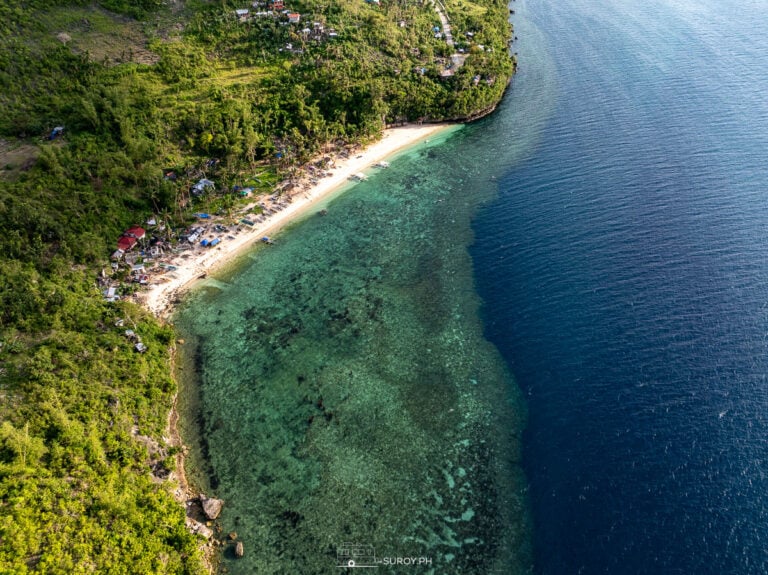 A stunning shot of Hermit’s Cove’s pristine coastline, showcasing the quiet beauty of its secluded beach, ideal for peaceful getaways and nature lovers.