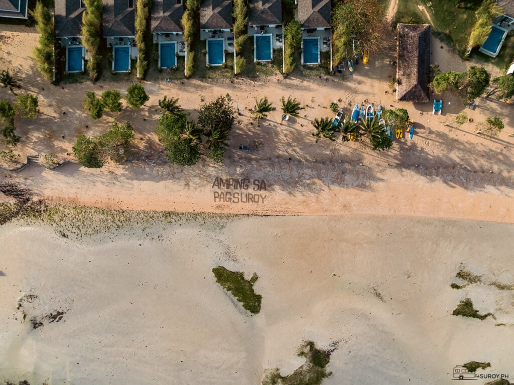 A view of Kandaya Resort’s villas with private pools lined up against the sandy shores. The message on the beach, “Amping sa Pagsuroy,” reminds guests to enjoy their journey safely and peacefully.